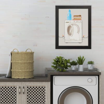 Laundry room wall art with a light grey background featuring a washing machine, folded clothes, and a blue detergent bottle for a realistic vibe. hung on the wall the laundry wall art under the washing machine