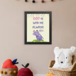 Colorful wall art featuring a cartoon elephant and the text 'God Is With Me Always' inspired by Matthew 28:20. displayed on the wall in a black frame