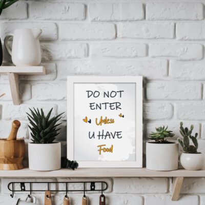 Do Not Enter Unless U Have Food kitchen wall art with black and orange fonts on a white background, accented by yellow decorative hearts. displayed on the table in a white frame