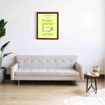 Infidu Bathroom Rules Wash, Brush And Always Flush Bathroom Wall Art with green and black text, small icons of a brush, and soap bubbles on a bright green background. a sofa below the wall art.