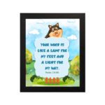 Cheerful dog character with Psalm 119:105 verse Your Word is like a lamp for my feet on a bright blue background. hung on the wall in a black frame