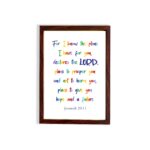 Colorful wall art featuring Jeremiah 29:11, For I Know The Plans I Have For You, with rainbow text on a white background. hung on the wall in a brown frame