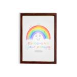 Cheerful rainbow wall art with the text Rainbows Are Your Promises in colorful letters, designed for kids' room decor. hung on the wall in a brown frame