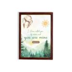 Watercolor wall art featuring a forest scene with the text I Have Called You By Name and You Are Mine from Isaiah 43:1. hung on the wall in a brown frame