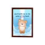 God Holds Me In The Palm Of His Hand Isaiah 49:16 Bible verse wall art for kids featuring a cartoon bear and fluffy clouds. hung on the wall in a brown frame