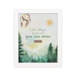 Watercolor wall art featuring a forest scene with the text I Have Called You By Name and You Are Mine from Isaiah 43:1. hung on the wall in a white frame