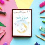 You Are a Child of God wall art featuring a white elephant on a crescent moon with stars and pastel flags. displayed on the wall in a brown frame in a colorful background