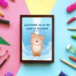 God Holds Me In The Palm Of His Hand Isaiah 49:16 Bible verse wall art for kids featuring a cartoon bear and fluffy clouds. hung on the wall in a brown frame in colorful background wall