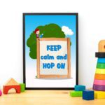 Keep Calm and Hop On a wooden sign with a girl, blue sky, and tree - General Verse Wall Art for kids. displayed on the table in a black frame