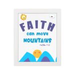 Wall art with the text Faith can move mountains from Matthew 17:20, featuring a sun rising over mountains. hung on the wall in a white frame