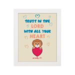 Cute teddy bear holding a heart with Trust in the Lord with all your heart text above, Proverbs 3:5 wall art design. hung on the wall in a white frame