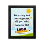 Be Strong And Courageous Psalm 31:24 Bible Verse Wall Art with sun and stars on a sky blue background for kids. hung on the wall in a black frame