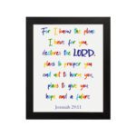 Colorful wall art featuring Jeremiah 29:11, For I Know The Plans I Have For You, with rainbow text on a white background. hung on the wall in a black frame