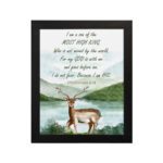 The lakeside scene with a deer and mountains features the verse I Am A Son Of The Most High King in calming colors. hung on the wall in a black frame