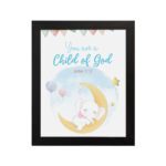 You Are a Child of God wall art featuring a white elephant on a crescent moon with stars and pastel flags. hung on the wall in a black frame