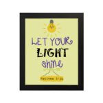 Infidu wall art featuring a lightbulb and the verse Let Your Light Shine from Matthew 5:16 in colorful fonts on a yellow background. hung on the wall in a black frame