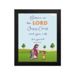 Wall art with a green field, trees, and cartoon figures of Jesus and children, featuring the text 'Believe in the Lord Jesus Christ and you will be saved. hung on the wall in a black frame