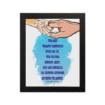 Wall art depicting two hands holding each other with the verse Let the little children come to me in blue text on a watercolor background. hung on the wall in a black frame