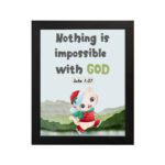 Wall art for kids featuring a happy cat in a Santa outfit holding a gift with the text Nothing is impossible with God. hung on the wall in a black frame