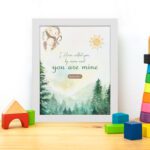 Watercolor wall art featuring a forest scene with the text I Have Called You By Name and You Are Mine from Isaiah 43:1. displayed on the table in a white frame