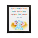 Colorful elephant wall art with the verse "Let everything that breathes praise the Lord!" for kids' room decor. hung on the wall in a black frame