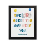 A cartoon panda in a blue shirt with the text Be joyful in hope, patient in affliction, faithful in prayer surrounded by yellow splashes. hung on the wall in a black frame