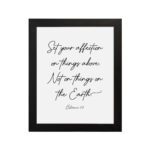 Set Your Affection on Things Above Colossians 3:2 Bible Verse Wall Art on a white background with black text and leaf decorations. hung on the wall in a black frame