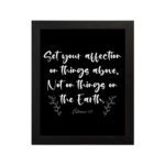 Set Your Affection on Things Above Colossians 3:2 Bible Verse Wall Art on black background with white text and leaf decorations. hung on the wall in a black frame