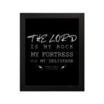 Bible wall art featuring Psalm 18:2 with the text The Lord is my rock, my fortress, and my deliverer in bold and cursive fonts. hung on the wall in a black frame