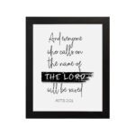 Bible wall art featuring Acts 2:21 with THE LORD highlighted in a black brushstroke on a white background. hung on the wall in a black frame