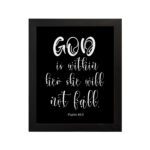 God Is Within Her, She Will Not Fall Psalm 46:5 Bible verse wall art in white text on a black background. hung on the wall in a black frame