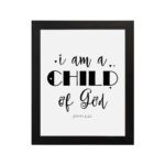 I Am A Child of God John 1:12 Christian Wall Art with black text on a white background hung on the wall in a black frame