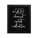 Christian wall art featuring Psalm 56:4 in bold white text on a black background. hung on the wall in a black frame