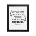 May The Lord Cause You To Flourish Both You And Your Children Psalm 115:14 Christian Wall Art with black text on white background. hung on the wall in a black frame