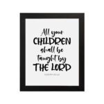 Infidu Christian wall art with Isaiah 54:13 verse in bold black text on a white background, All Your Children Shall Be Taught By The Lord. hung on the wall in a black frame