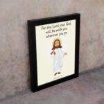 Jesus holding a staff with the verse For the Lord your God will be with you on cream background wall art for kids. displayed on the wall in a black frame