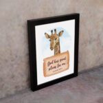 Jeremiah 29:11 Bible verse wall art featuring a cheerful giraffe on a sky-blue background, designed for children's rooms. displayed on the wall in a black frame