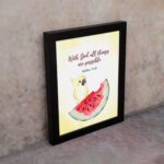 With God, All Things Are Possible Matthew 19:26 Bible Verse Wall Art featuring a bird and watermelon design for kids. displayed on the wall in a black frame