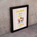 Christian wall art with happy children holding hands and Psalm 127:3 text 'Children are a gift from the Lord. displayed on the wall in a black frame