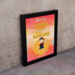 Colorful wall art featuring a happy child holding a heart with the quote You Are Loved Beyond Measure and Romans 8:38. displayed on the wall in a black frame