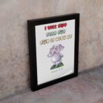 Cartoon elephant with a raised trunk and colorful text I Will Not Fear For God Is With Me - Isaiah 41:10) Bible Verse Wall Art. displayed on the wall in a black frame