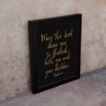 May The Lord Cause You To Flourish Both You And Your Children - Psalm 115:14 Christian Wall Art in golden text on black background. displayed on the wall in a black frame