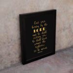 Cast Your Burden on the Lord Psalm 55:22 gold text on black background Christian wall art. Wall Art displayed on the wall in a black frame