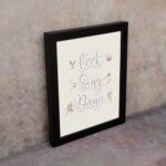 Cook Sing Dance kitchen wall art with pastel pink tones, a beige background, and musical notes.