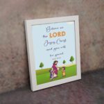 Wall art with a green field, trees, and cartoon figures of Jesus and children, featuring the text 'Believe in the Lord Jesus Christ, and you will be saved. displayed on the wall in a white frame