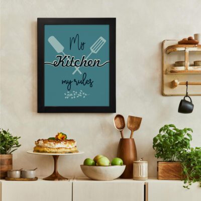 My Kitchen My Rules kitchen wall art with a green background, black and white elements, and creatively styled bold and cursive text. There is a vegetable table, and above it, there is wall art.