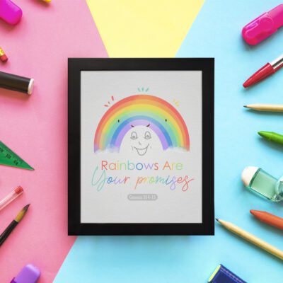 Cheerful rainbow wall art with the text Rainbows Are Your Promises in colorful letters, designed for kids' room decor. displayed on the wall in a black frame in a colorful background