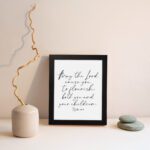 Elegant wall art featuring Psalm 115:14 in cursive font, black text on a white background. Wall Art displayed on the wall in a black frame