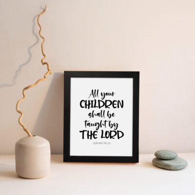 Infidu Christian wall art with Isaiah 54:13 verse in bold black text on a white background, All Your Children Shall Be Taught By The Lord. displayed on the wall in a black frame