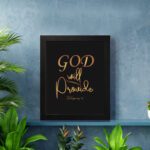 Infidu wall art with the text "GOD will provide" in gold font on a black background, referencing Philippians 4:19. displayed on the wall in a black frame